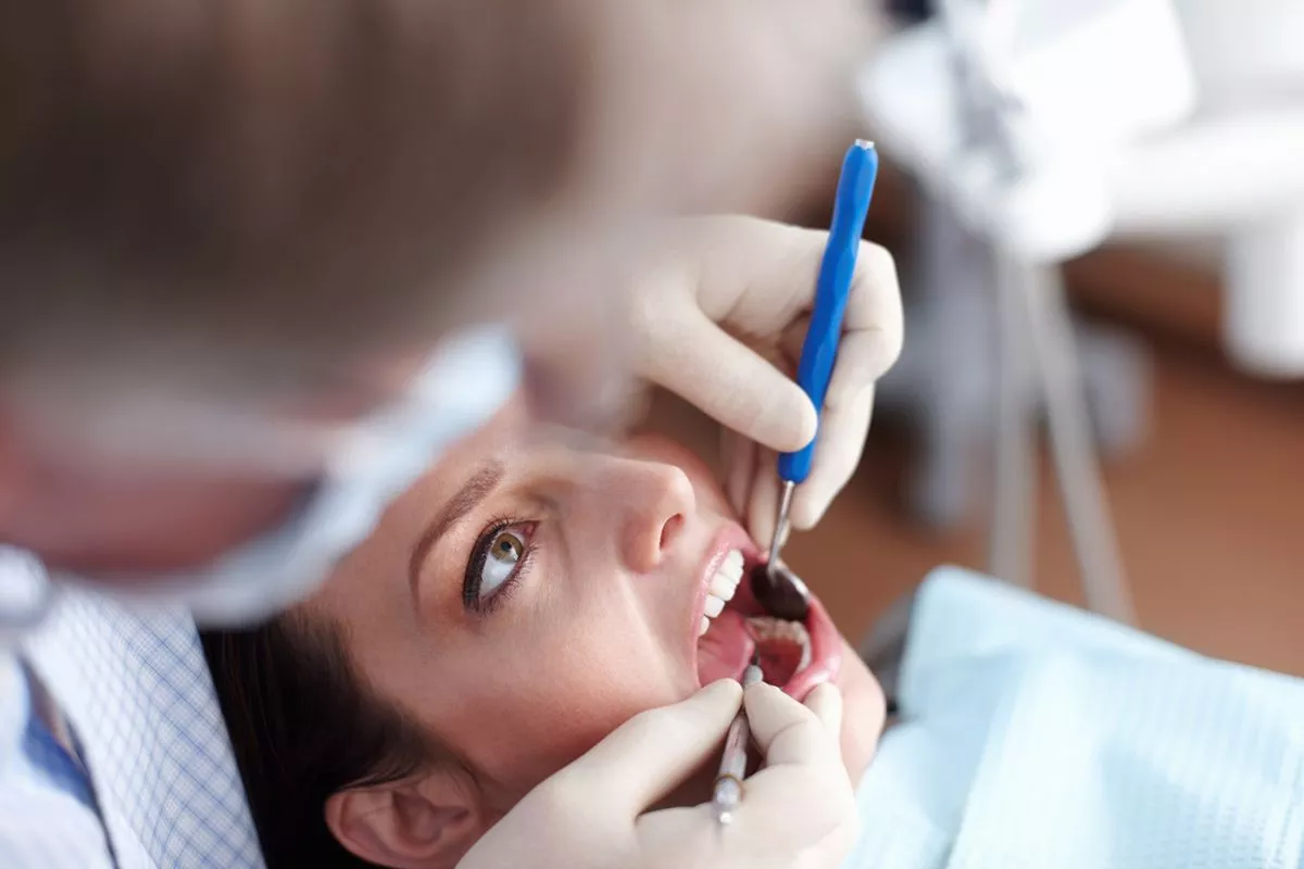 patient-visiting-dentist-high-angle-view-dentist-checking-patients-teeth-copia